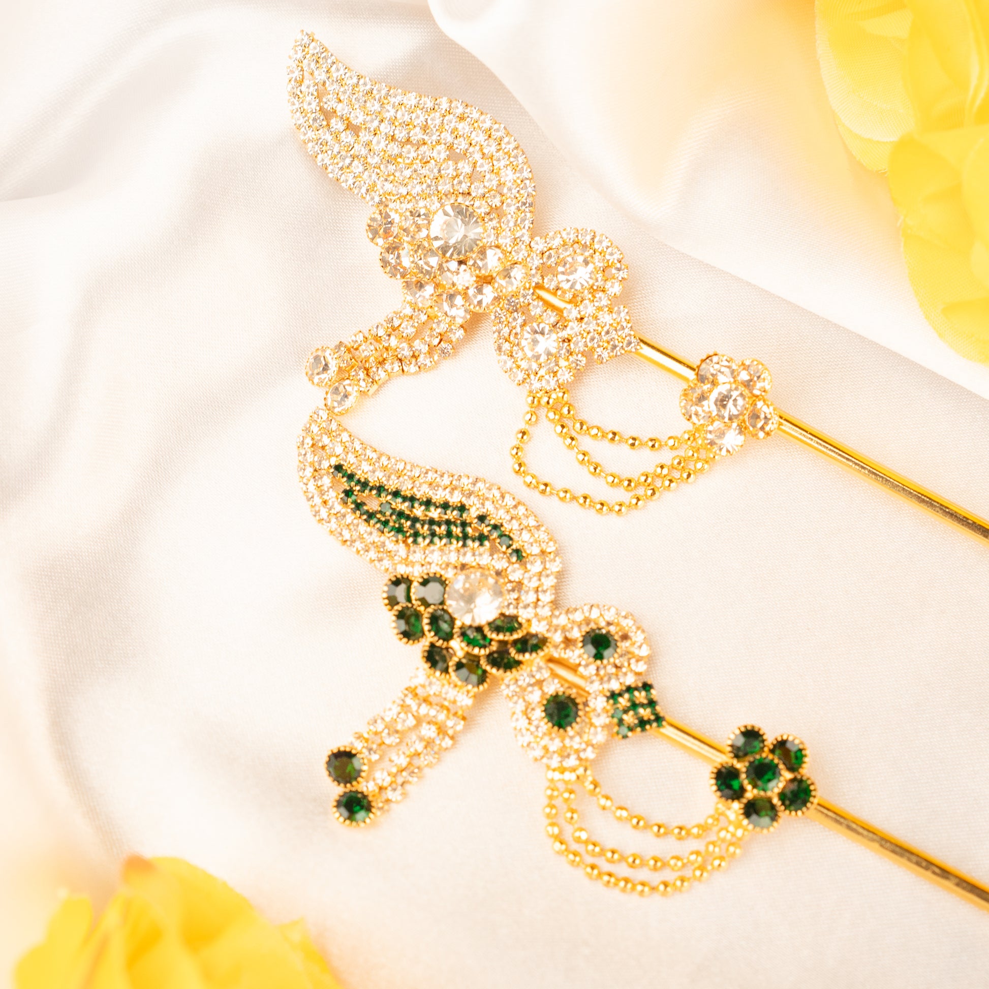 Gold Basuri  with green gemstones on a white background for laddu gopal 