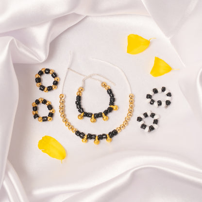 Set of beaded jewelry including necklaces and earrings on a white fabric background nazariya collection for laddu Gopal .